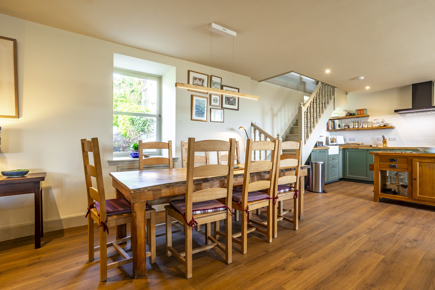 Dining table and kitchen beyond