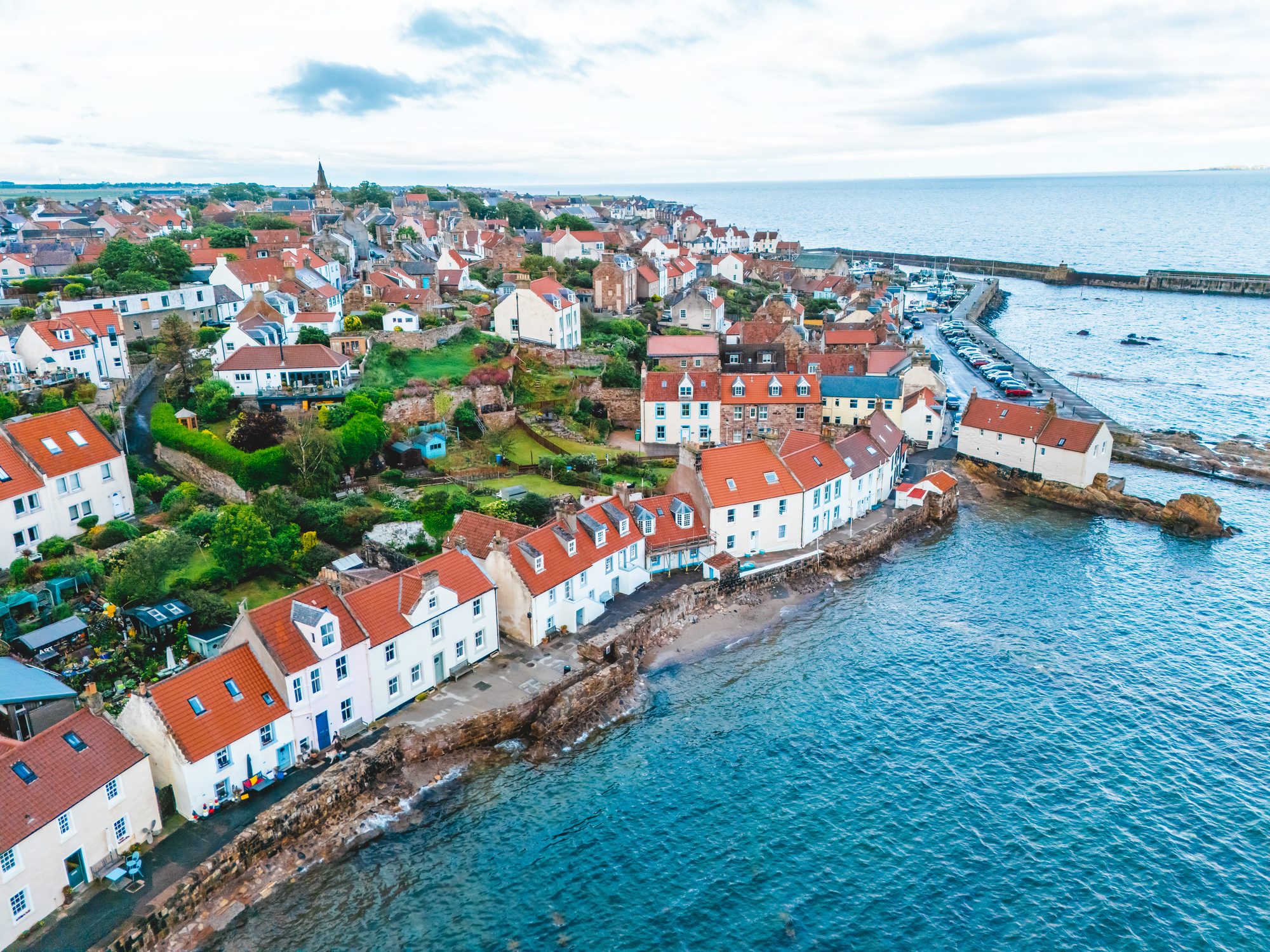 Aerial view along West Shore, Pittenweem, with the row of houses at the water's edge